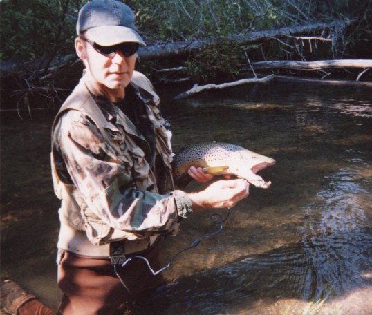 Feral with a hook-jawed brown trout, Pigeon River